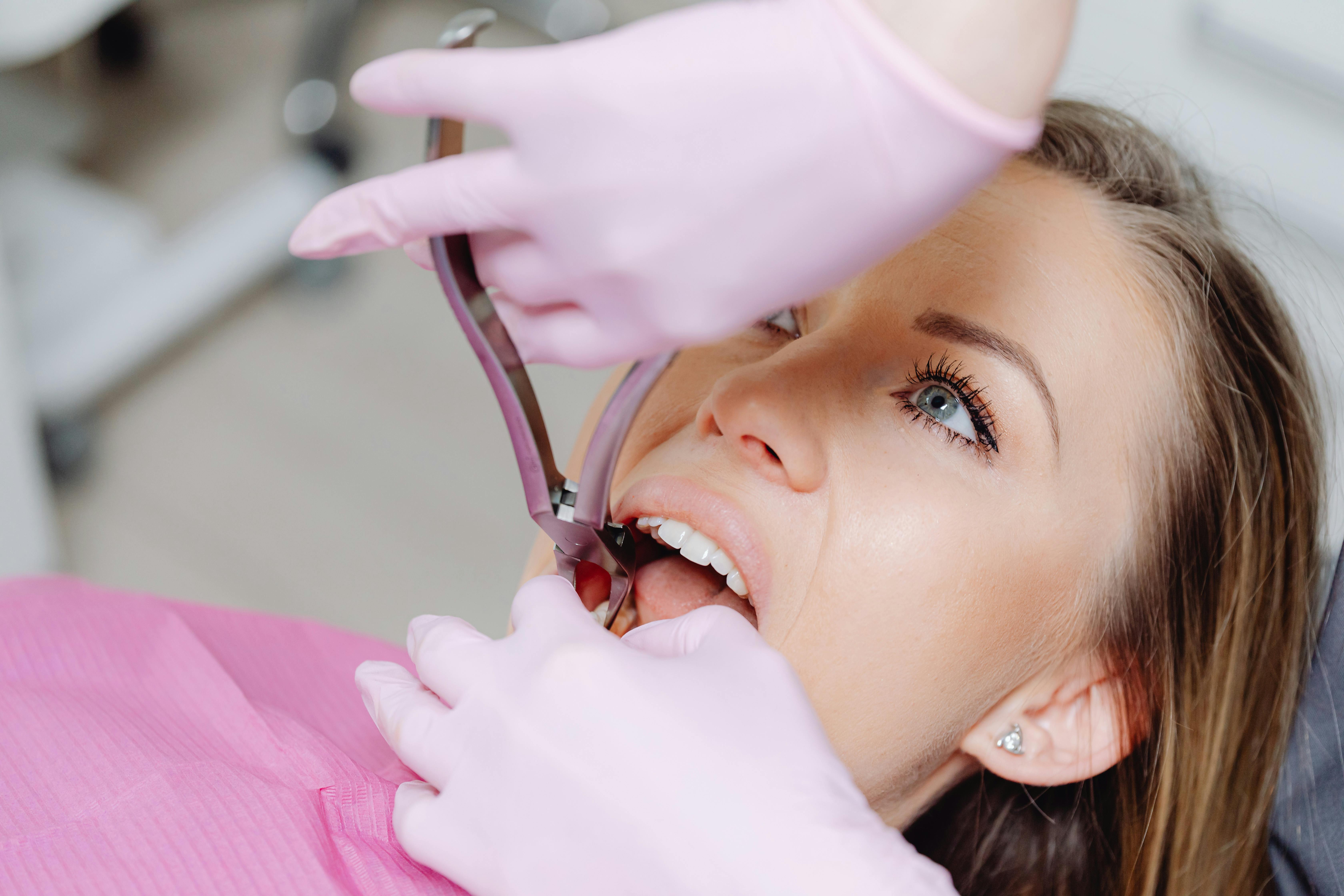 What are my options for missing teeth Young woman getting dental exam after going through procedure for missing